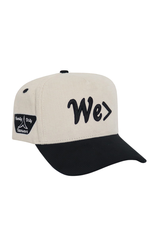 Beige and black cap with 'We' logo on a white background