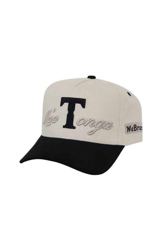 A baseball cap with an off-white crown and a black curved brim. The front features a large black embroidered letter 'T' with 'Misa Tonga' embroidered in black script below it.