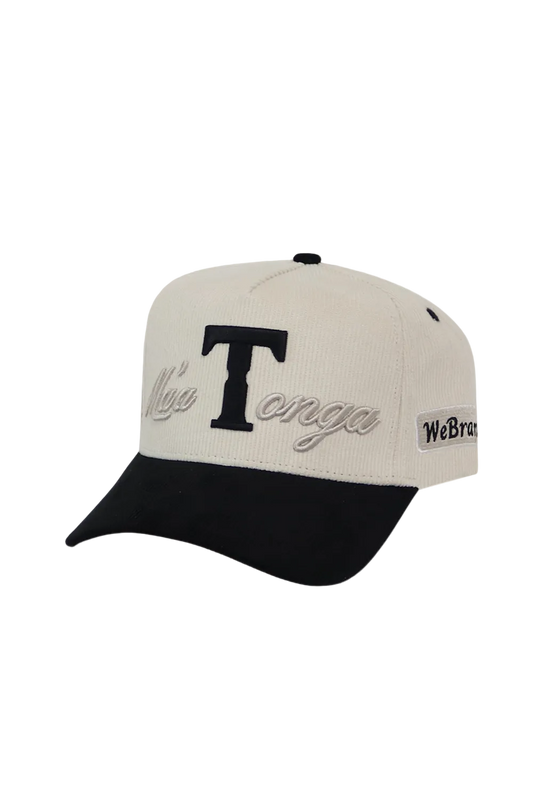 A baseball cap with an off-white crown and a black curved brim. The front features a large black embroidered letter 'T' with 'Misa Tonga' embroidered in black script below it.