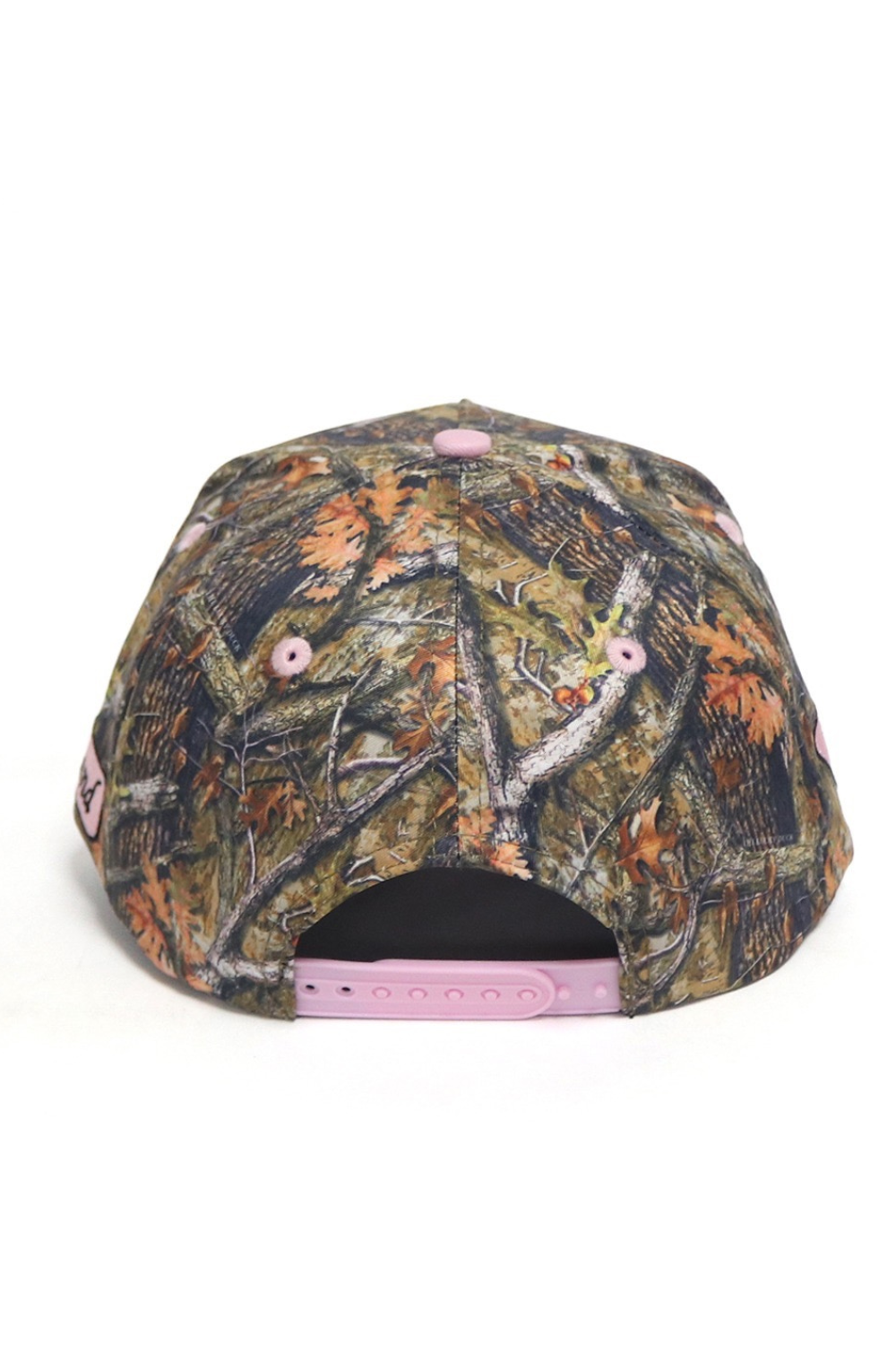 Camouflage-patterned cap with pink accents on a white background