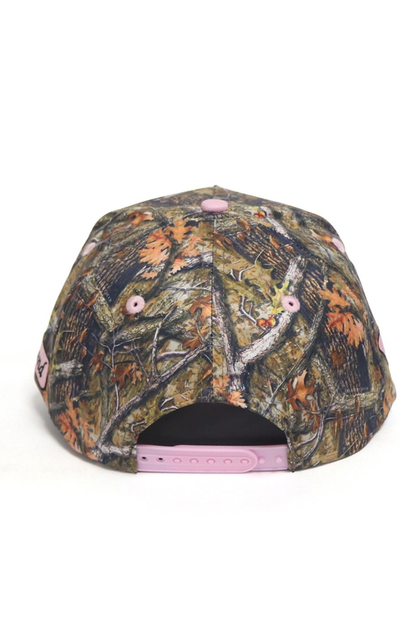 Camouflage-patterned cap with pink accents on a white background