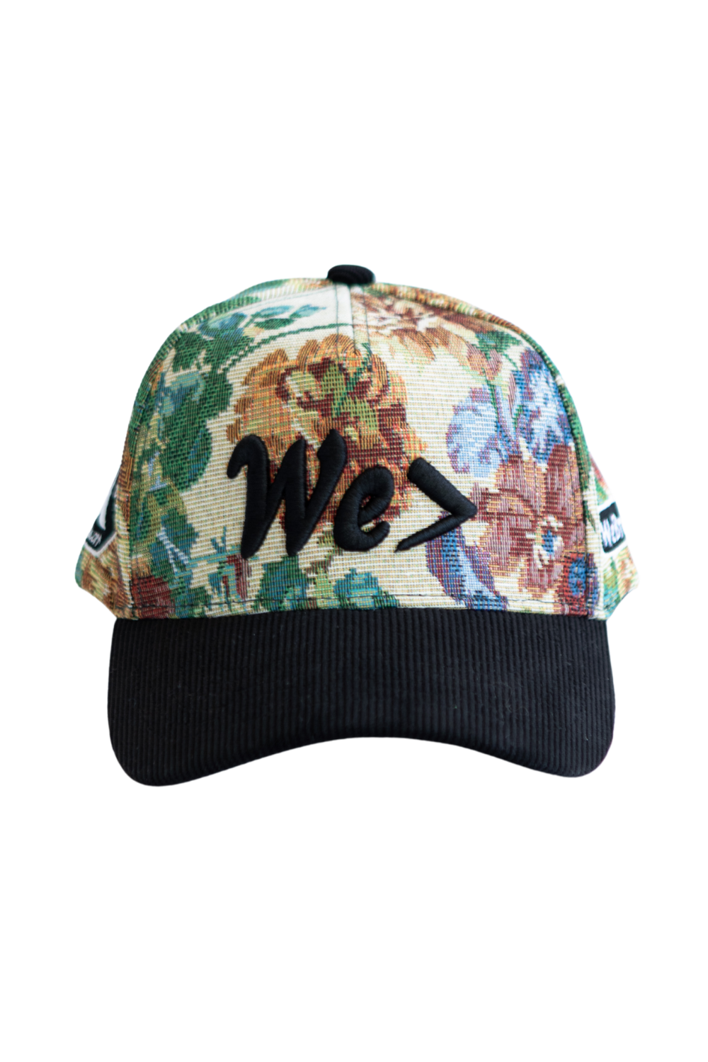 Floral-patterned cap with 'We' text on a white background