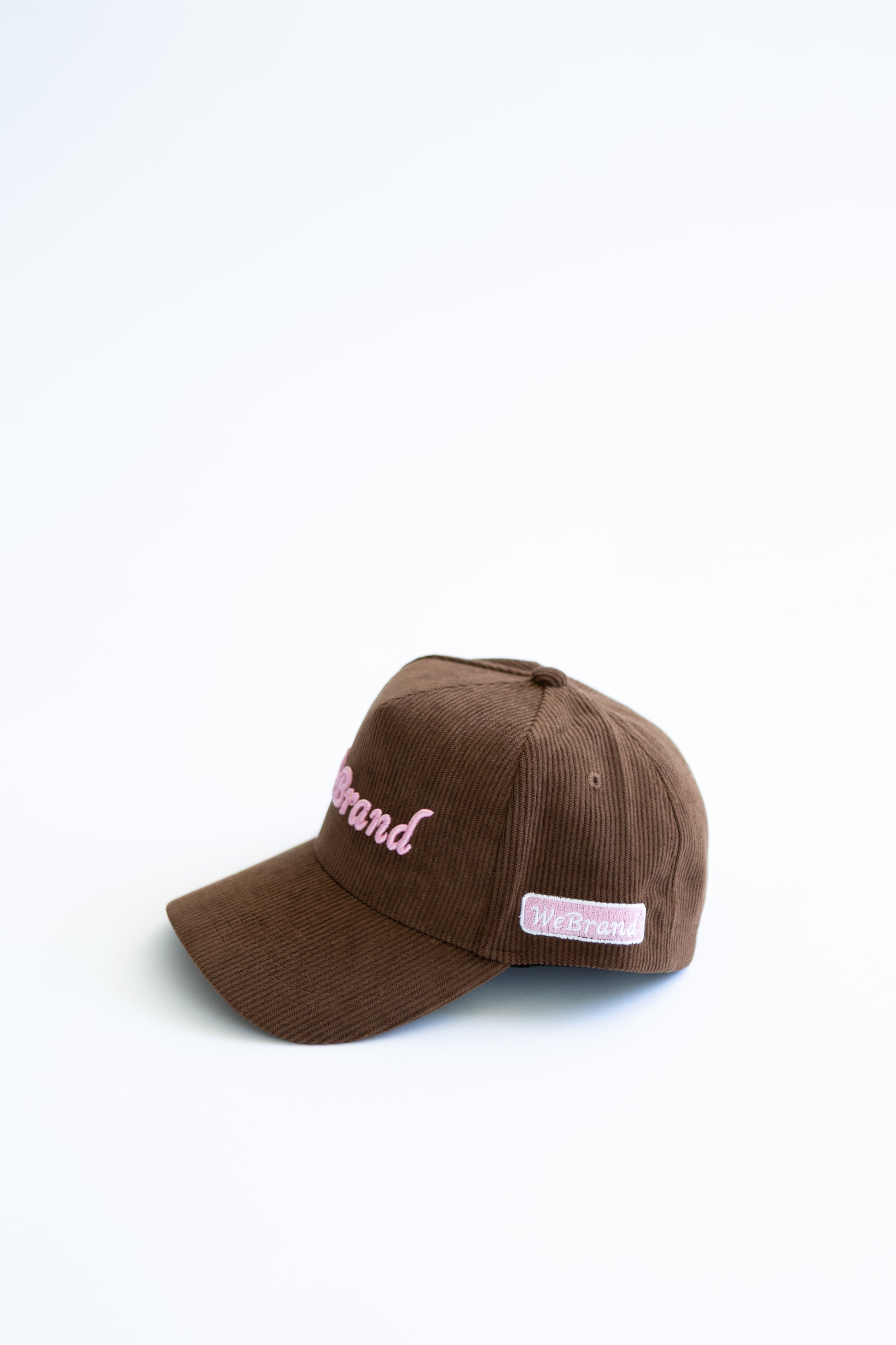 Brown cap with pink text on a white background