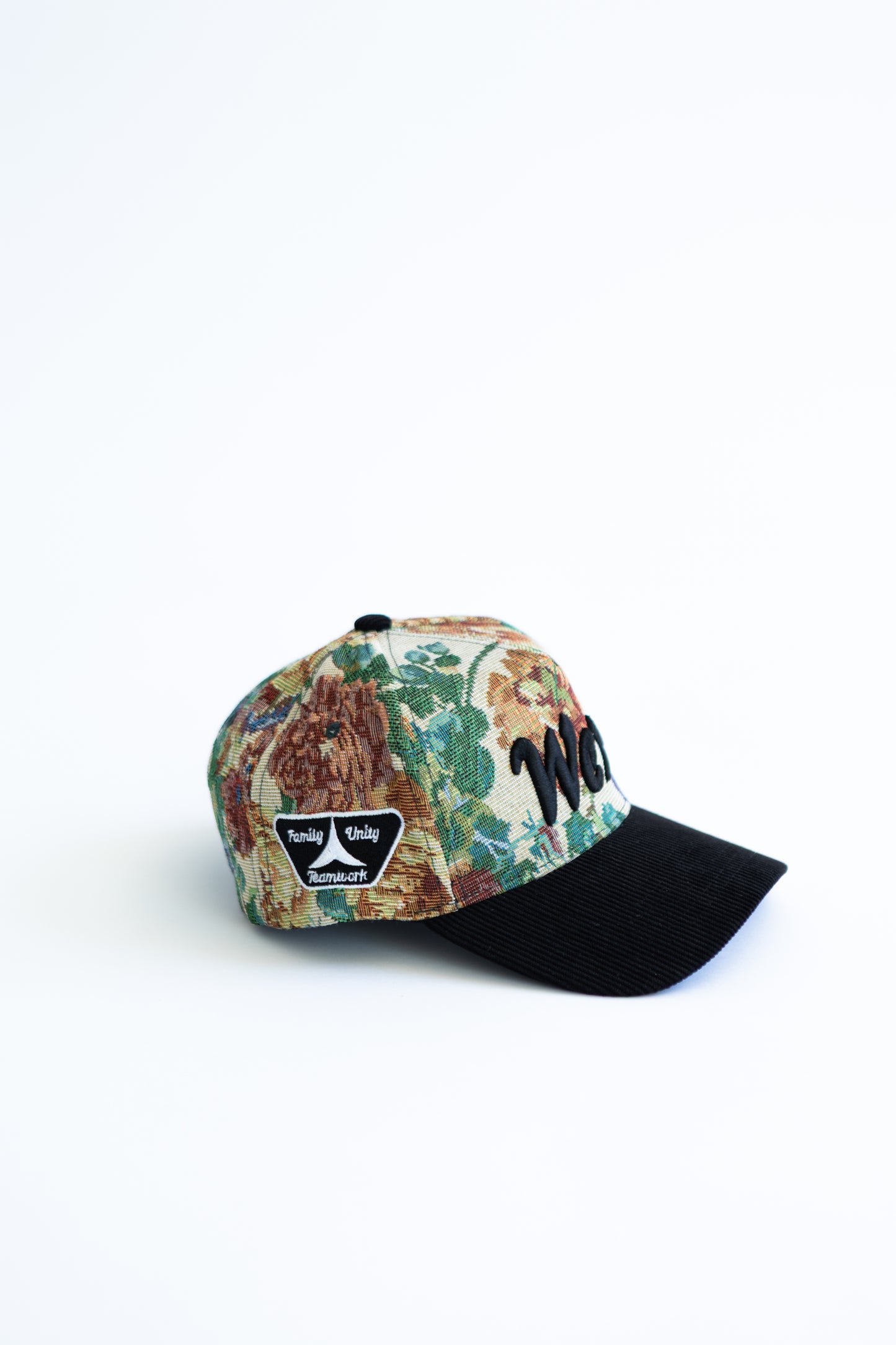 Floral-patterned cap with black brim on a white background