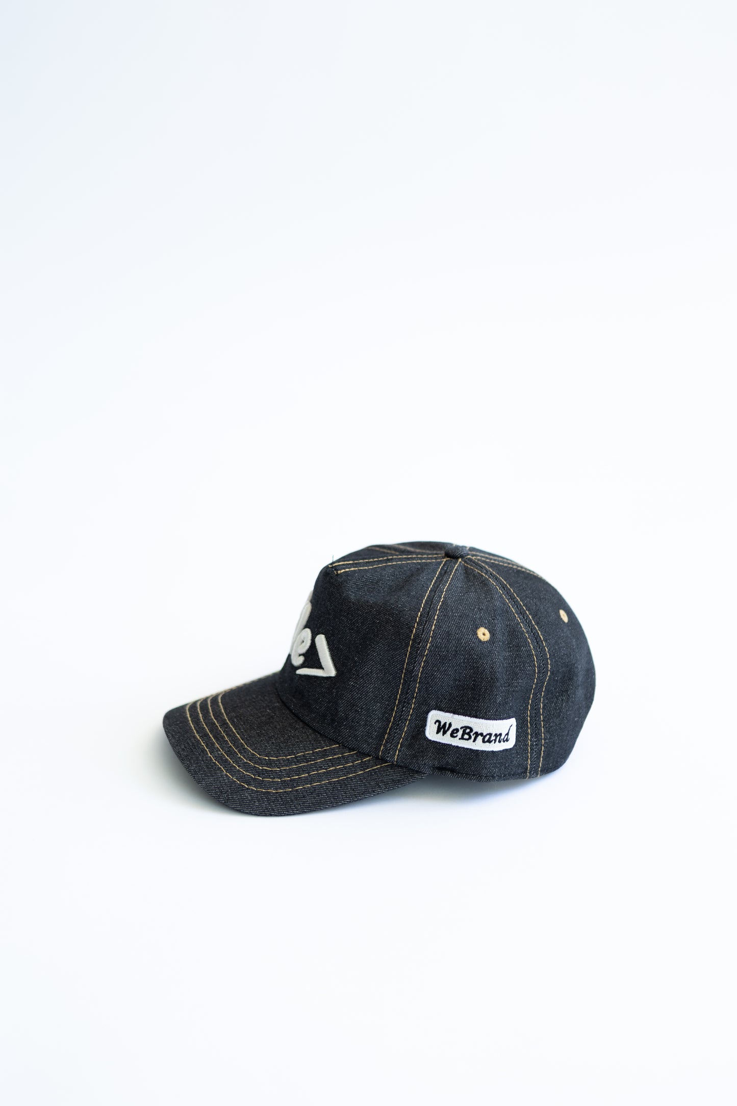 Dark denim cap with visible branding on a white background