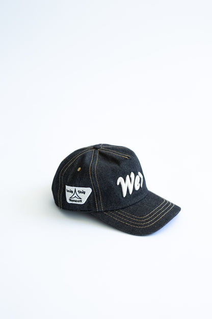 Denim cap with white text on a white background