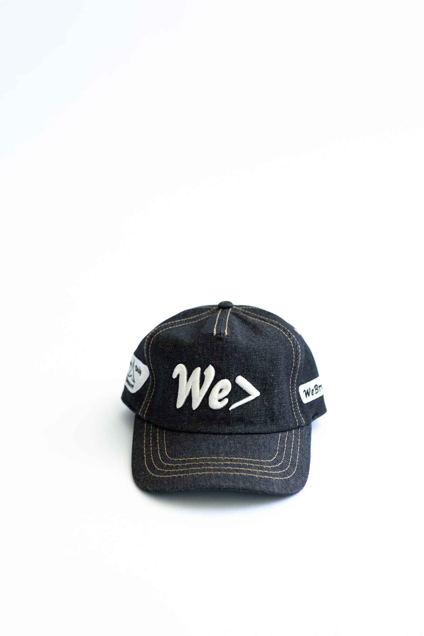 Denim cap with white text on a white background