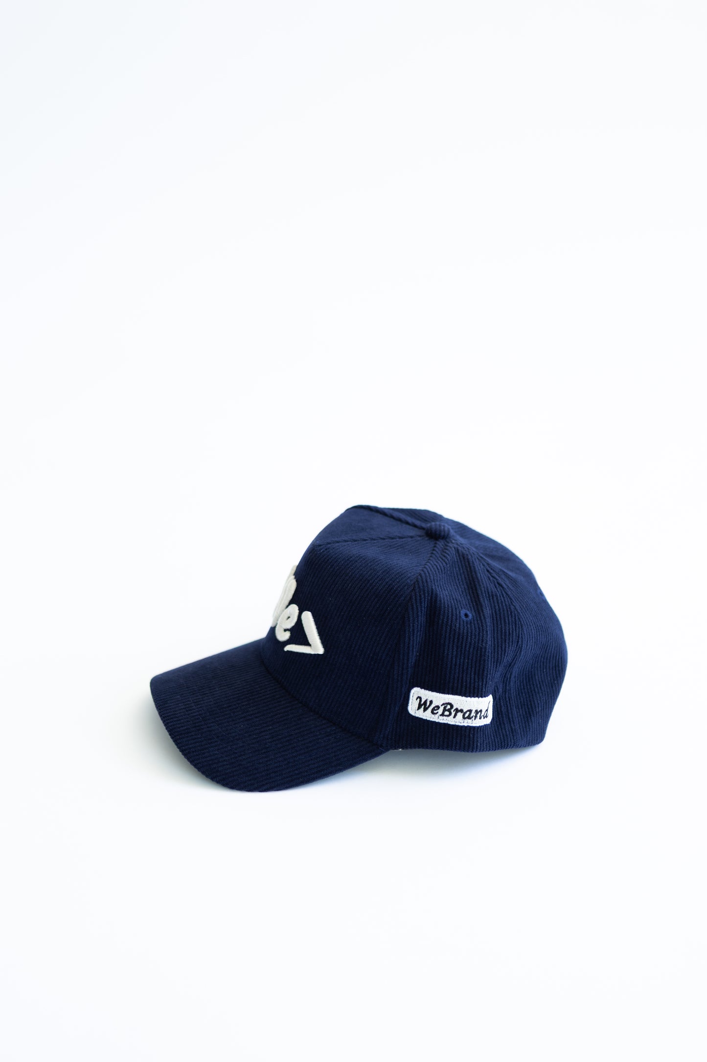 Navy blue cap with white logo on a white background