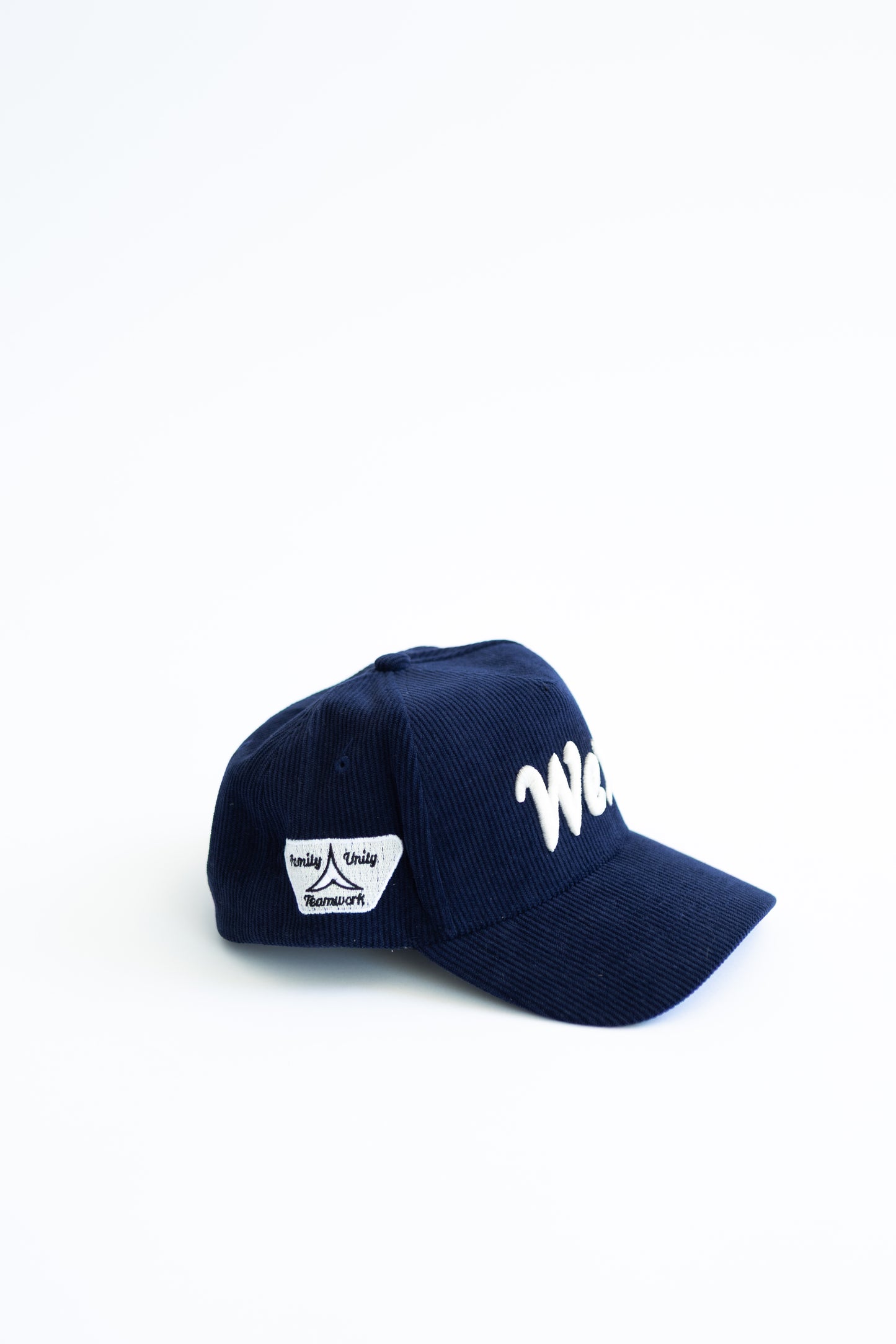 Navy blue cap with white text on a white background