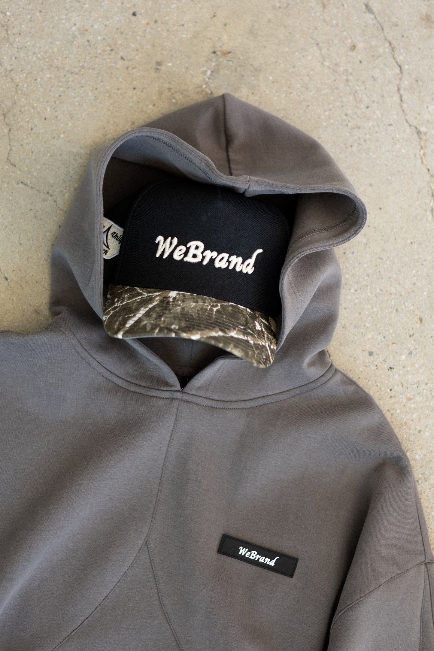 Hat with camo brim inside a hoodie