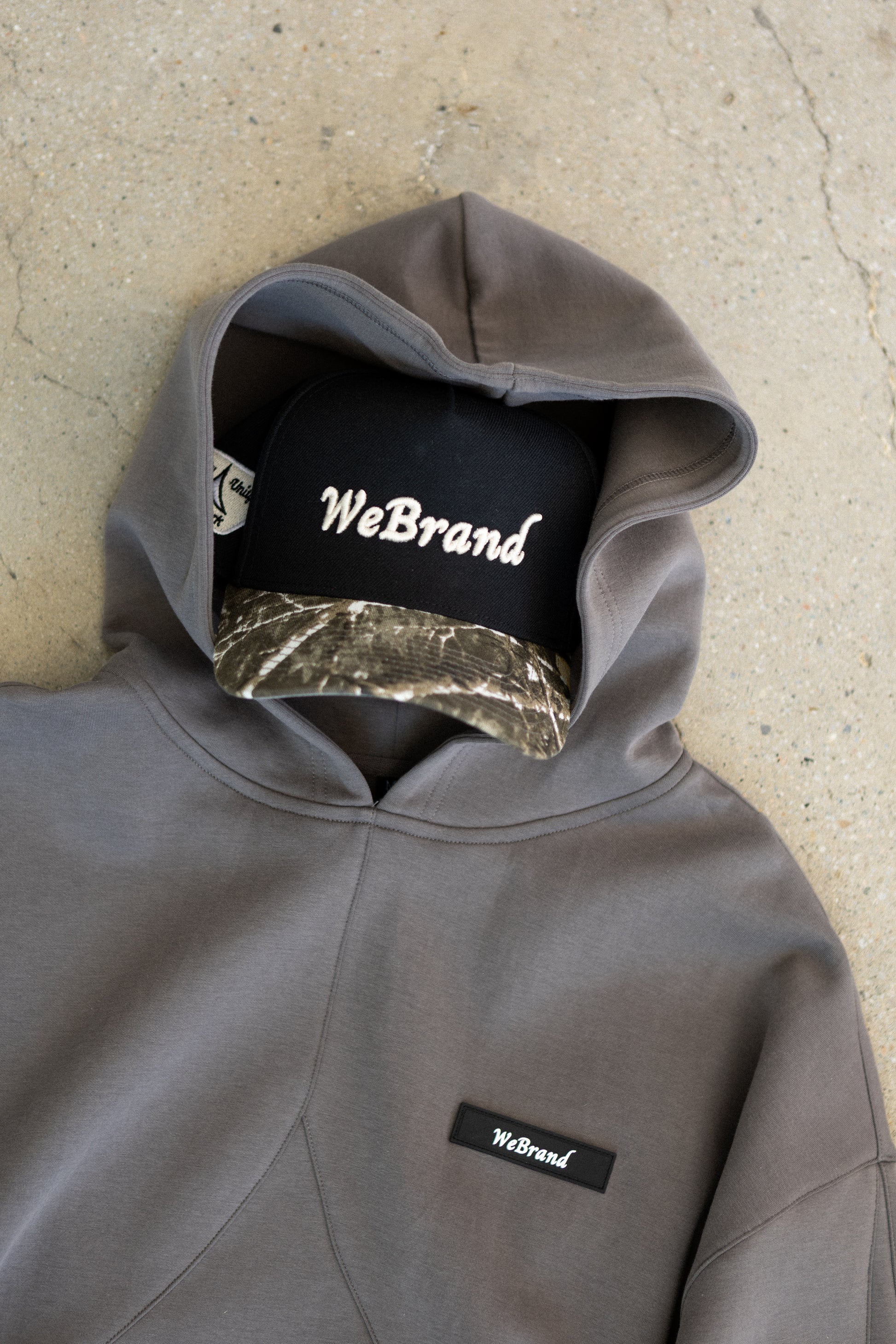 Hat with camo brim inside a hoodie