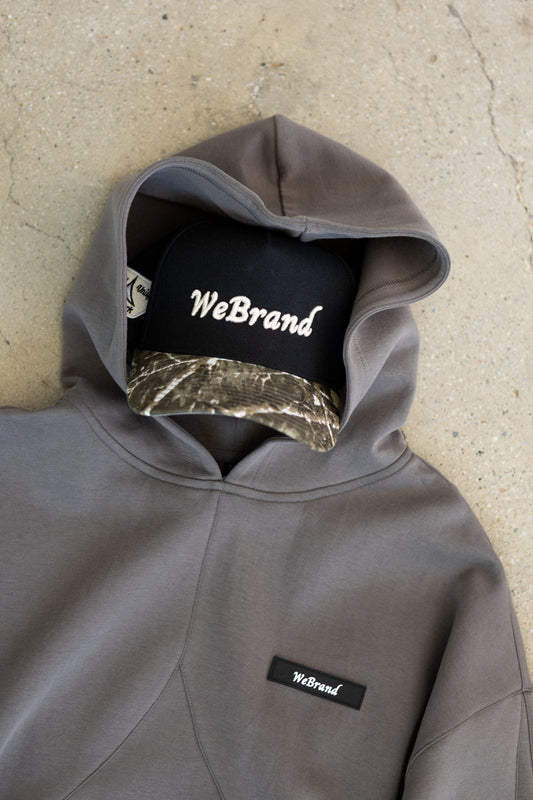 Hat with camo brim inside a hoodie