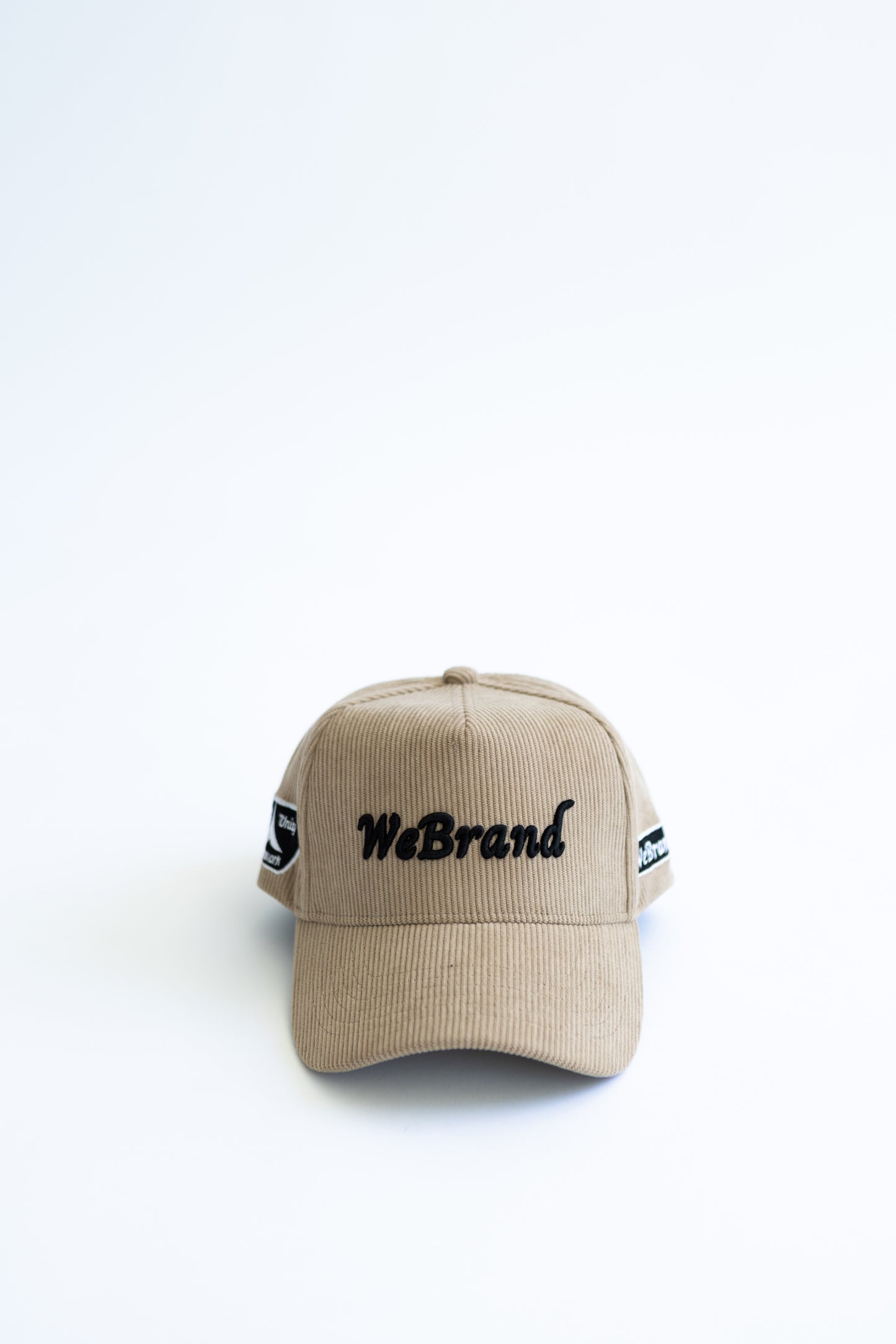 Beige cap with 'WeBrand' logo on a white background