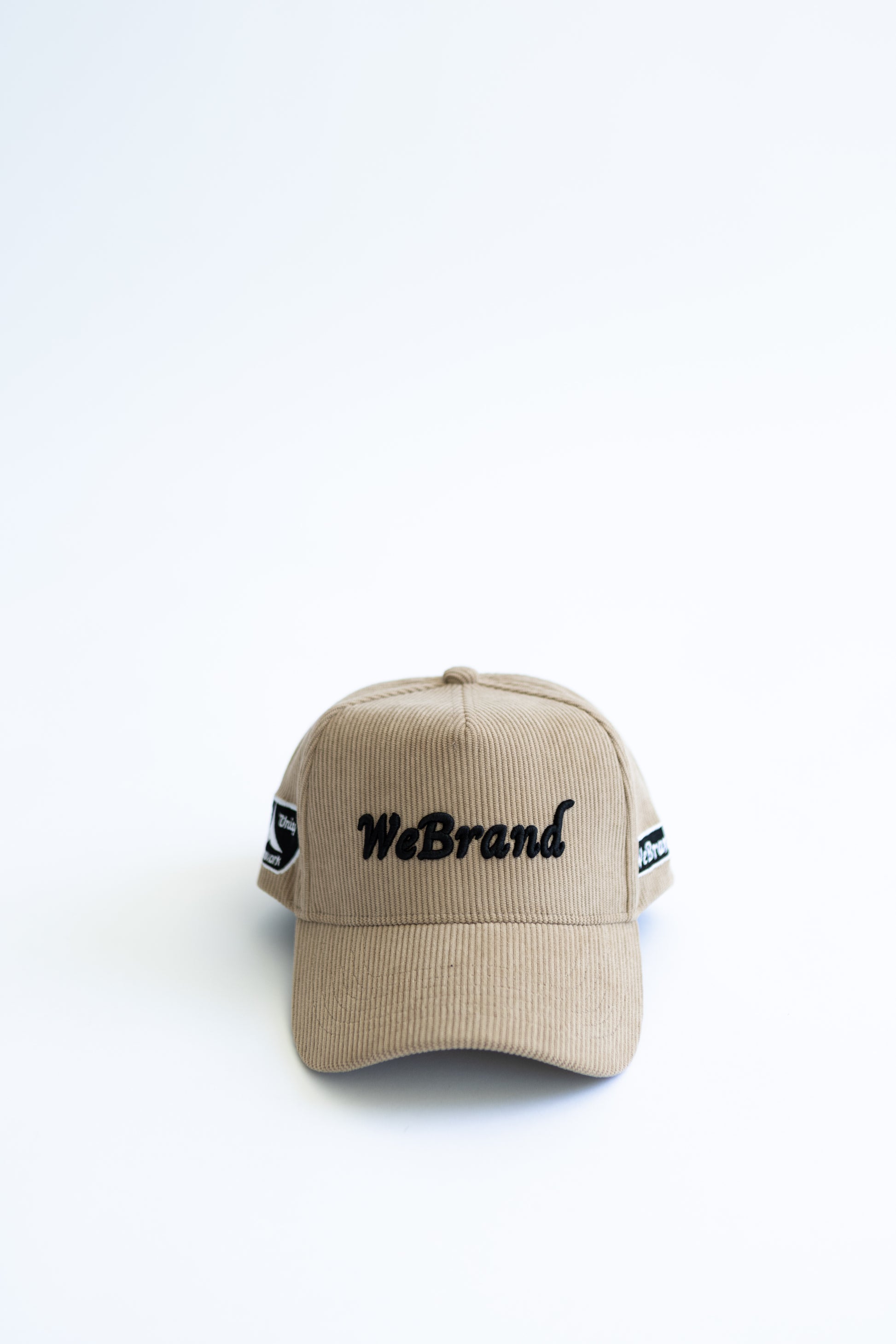 Beige cap with 'WeBrand' logo on a white background