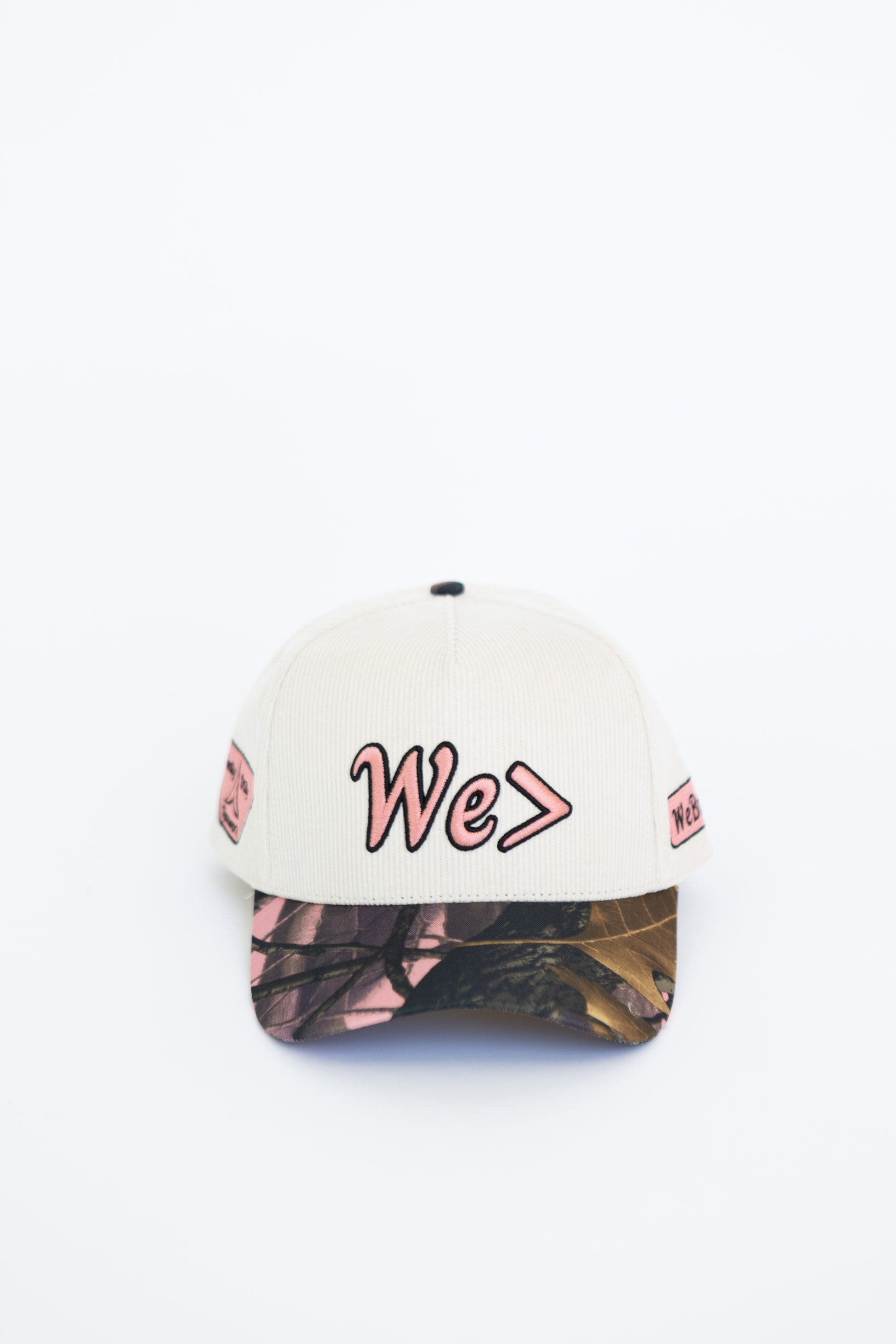 Cap with 'We>' text on a white background
