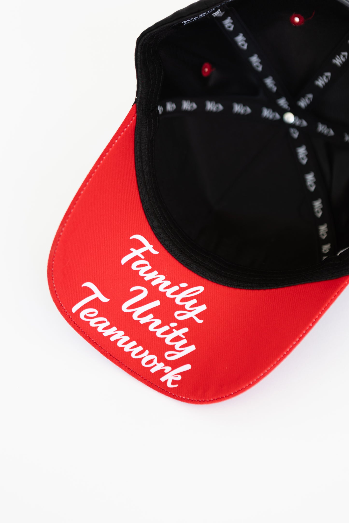 Red and black cap with 'Family Unity Teamwork' text on a white background
