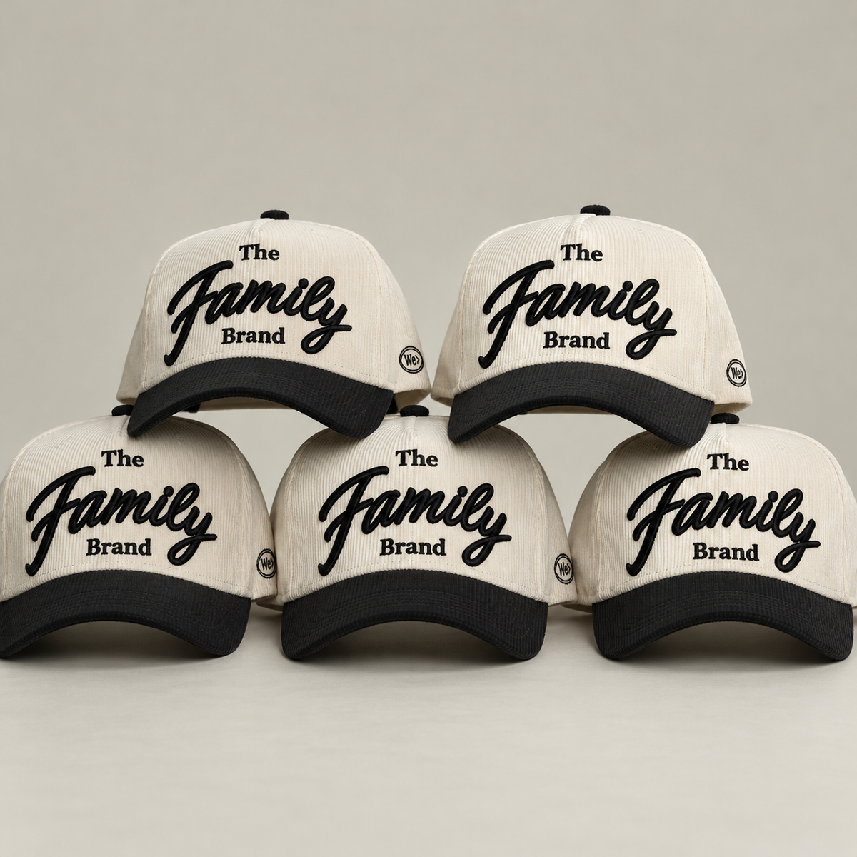 Collection of cream and black The Family Brand corduroy hats arranged together
