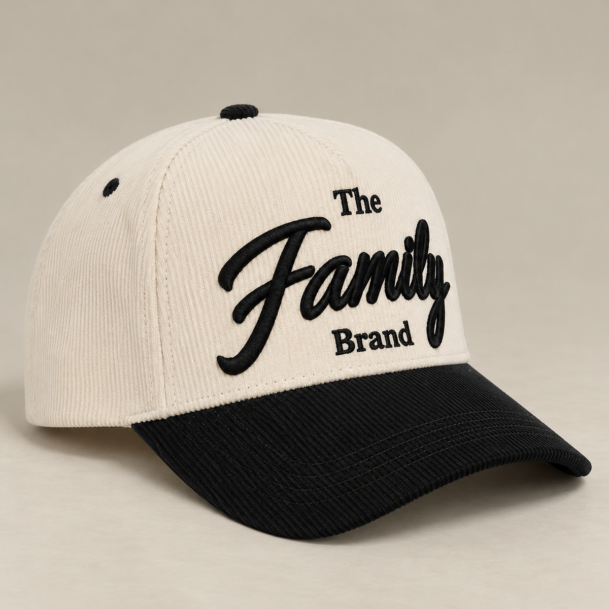 Cream and black Family Brand corduroy baseball cap showing raised embroidery