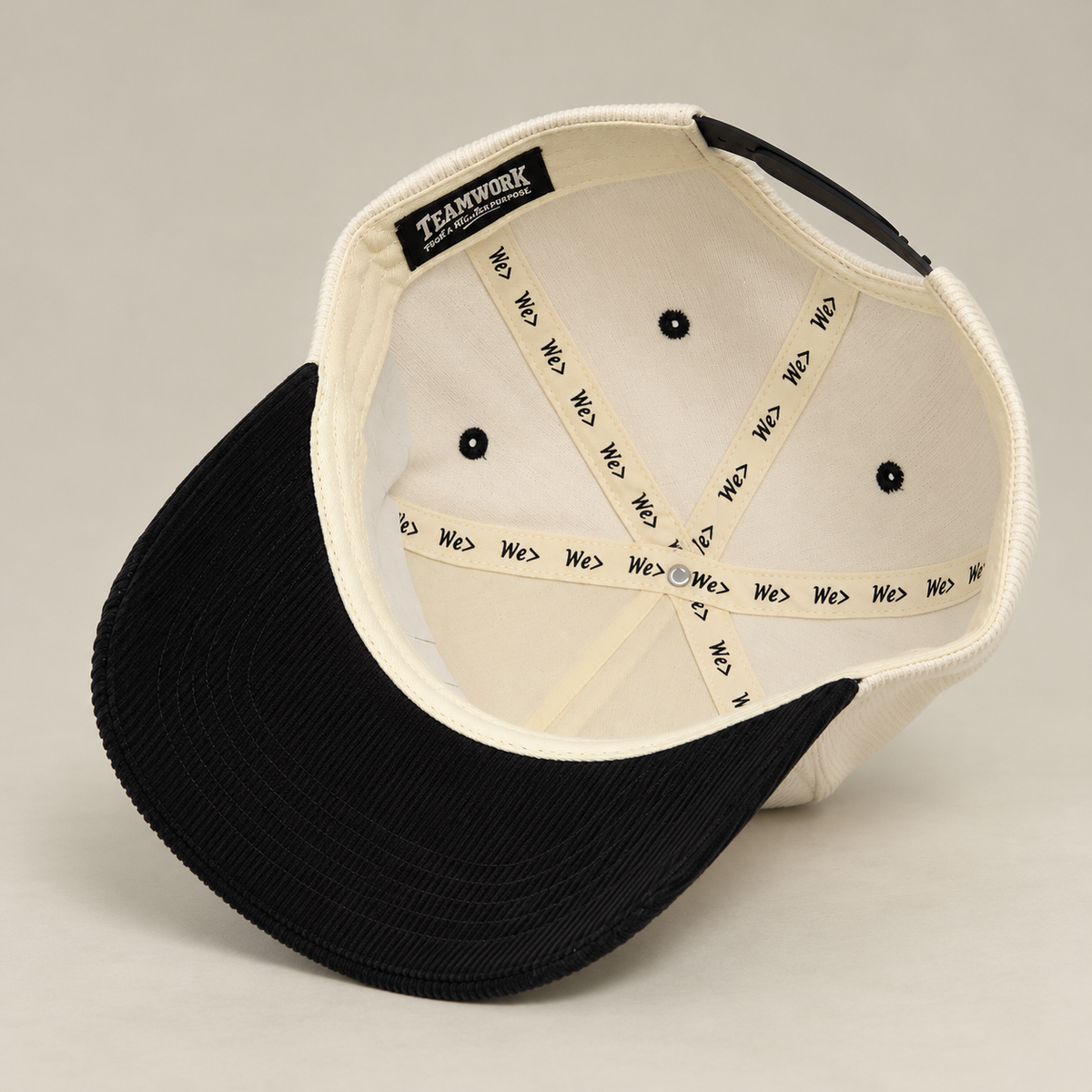 Interior of WE> Family Brand corduroy hat showing branded seam tape and label
