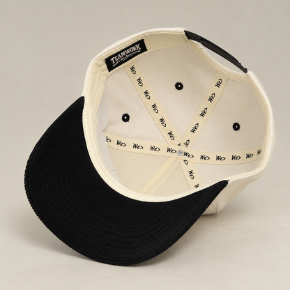 Interior of WE> Family Brand corduroy hat showing branded seam tape and label