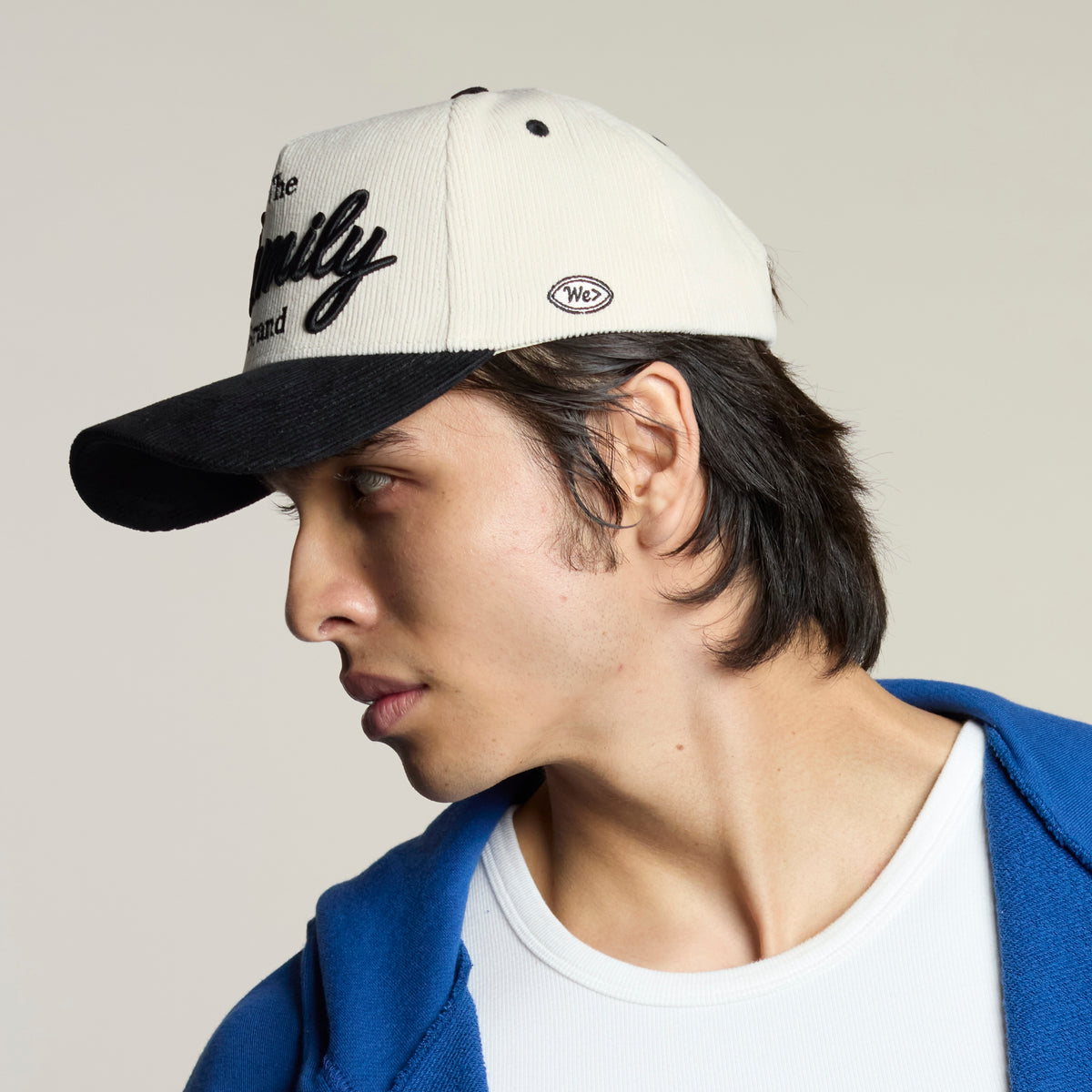 Side view of the Family Brand cream corduroy hat on model
