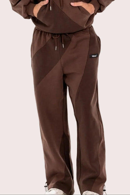 Man wearing a brown tracksuit on a white background