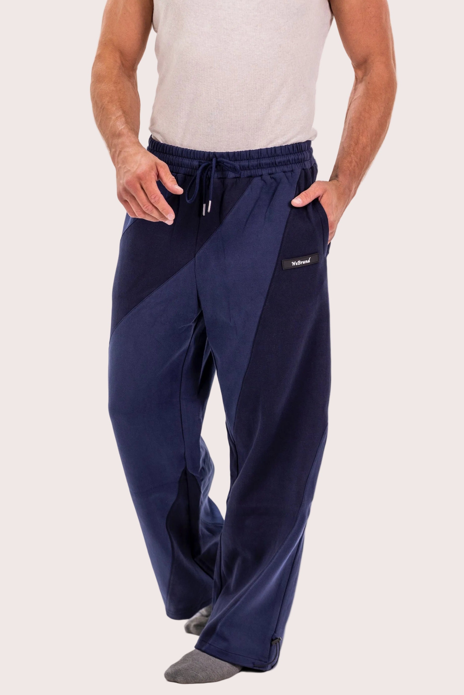 Navy blue pants worn by a person on a white background
