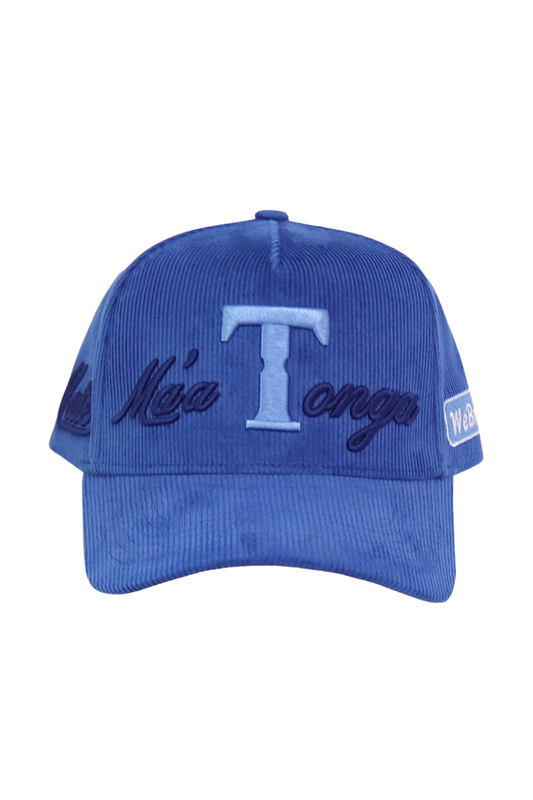 A royal blue corduroy baseball cap featuring an embroidered light blue 'T' logo in the center, with dark blue script embroidery on the sides and a small white patch on the side, shown against a plain white background.