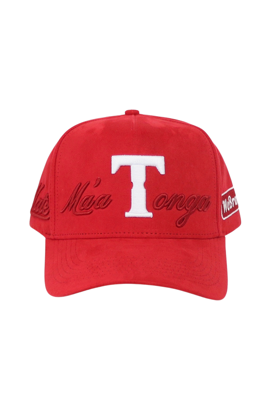 A red baseball cap featuring a large white embroidered 'T' on the front, with 'Mā Tonga' embroidered in red script across the sides and a small white 'Wet Dream' logo patch on the side.
