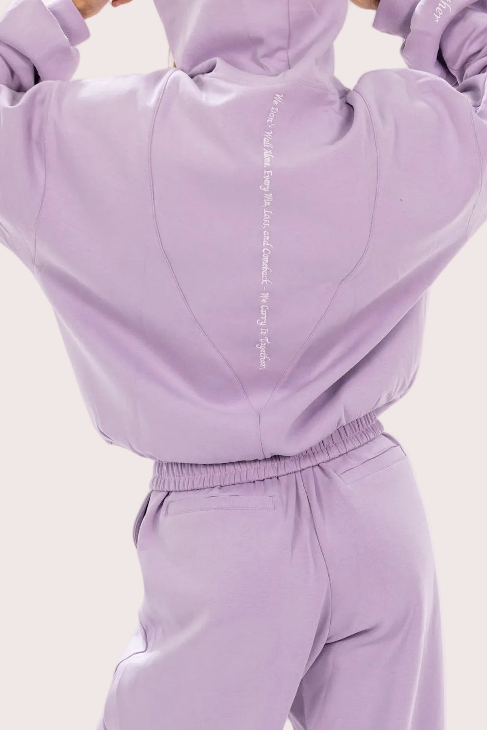 Lavender tracksuit with a plain background